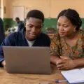 Nigerian technical college student checking NABTEB Federal Technical College placement status on a laptop