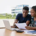 A Nigerian university student and parent reviewing admission and school-fee plans on campus