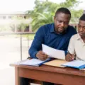 Parent and secondary-school student reviewing admission documents in an illustrative scene