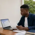 Nigerian university applicant reviewing a supplementary Post-UTME application checklist beside a laptop