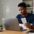 Nigerian polytechnic student checking a school payment on a laptop beside a receipt and a security shield illustration