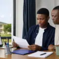 Nigerian admission candidate and parent reviewing an academy admission document