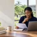 Nigerian undergraduate student preparing an online scholarship application at a university study desk